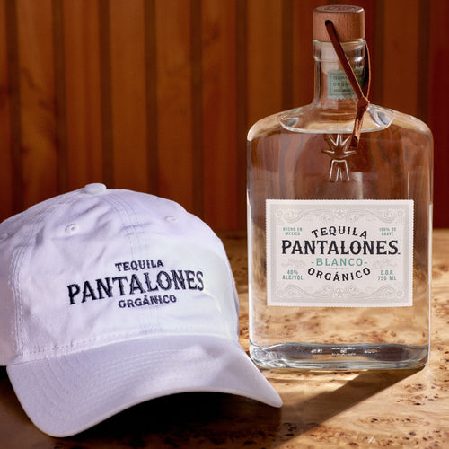 Pantalones Blanco Tequila made from 100% Blue Weber agave with white dad hat