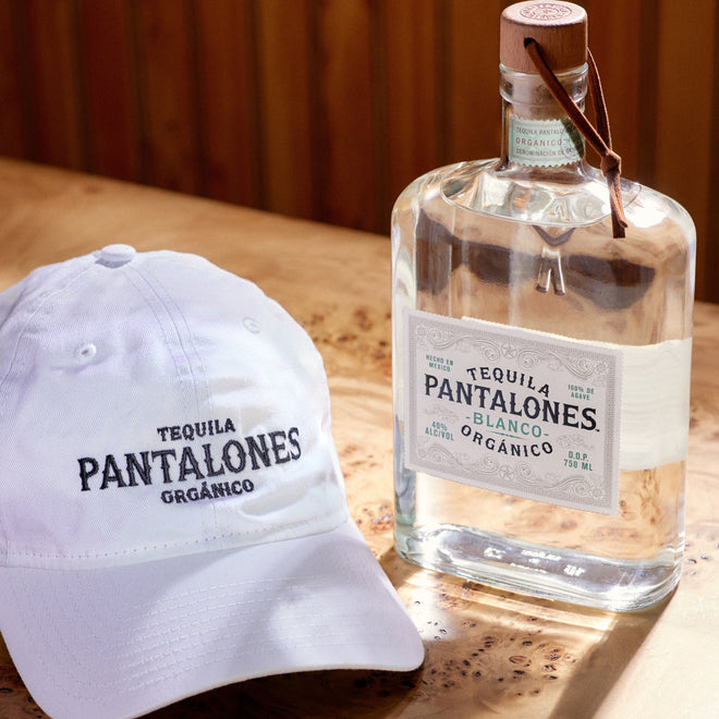 Pantalones Blanco Tequila made from 100% Blue Weber agave with white dad hat