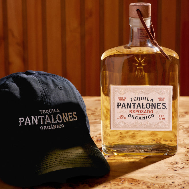 Pantalones Reposado Tequila aged in oak barrels with classic black dad hat